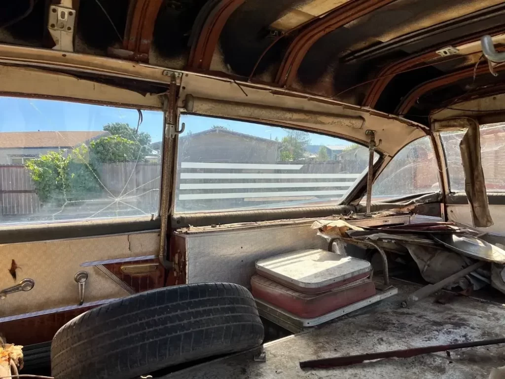 1960 Cadillac Superior Ambulance Rescuer in side rear, jump seat down