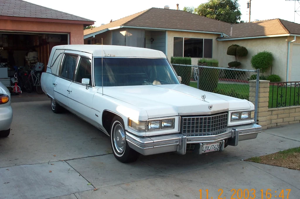 White 1976 Cadillac Superior Hearse Ambulance Combo passenger side and front view